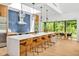 Modern kitchen with a large island, stylish pendant lighting, and adjacent dining area with lush views at 295 Lystra Preserve Dr, Chapel Hill, NC 27517