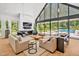 Sun-filled living room with soaring windows overlooking the pool and manicured backyard; modern style at 295 Lystra Preserve Dr, Chapel Hill, NC 27517