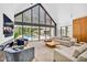 Airy living room with vaulted ceilings, backyard pool access, and comfortable modern furnishings at 295 Lystra Preserve Dr, Chapel Hill, NC 27517