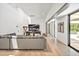 Open concept living room featuring high ceilings, modern furnishings, and hardwood floors with a polished hallway at 295 Lystra Preserve Dr, Chapel Hill, NC 27517