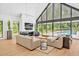 Spacious living room boasts floor-to-ceiling windows offering serene pool views and modern design at 295 Lystra Preserve Dr, Chapel Hill, NC 27517