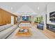 Bright, open living room with modern furnishings, fireplace, and seamless flow to the kitchen and dining areas at 295 Lystra Preserve Dr, Chapel Hill, NC 27517