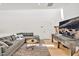 Bright living room with a gray sectional sofa, and light hardwood floors with modern furnishings at 295 Lystra Preserve Dr, Chapel Hill, NC 27517