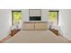 Cozy primary bedroom featuring neutral decor, side tables with lamps, and a large decorative abstract painting at 295 Lystra Preserve Dr, Chapel Hill, NC 27517