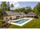 Aerial view showcasing a large pool, spa and luxury modern home with an outdoor kitchen area at 295 Lystra Preserve Dr, Chapel Hill, NC 27517