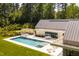 Luxury home showcasing a pristine pool and modern architectural design with an outdoor lounge area at 295 Lystra Preserve Dr, Chapel Hill, NC 27517