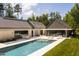 Aerial view showcasing a large pool, spa and luxury modern home with lush green landscaping at 295 Lystra Preserve Dr, Chapel Hill, NC 27517