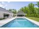 Aerial view showcasing a large pool, spa and luxury modern home with lush landscaping at 295 Lystra Preserve Dr, Chapel Hill, NC 27517