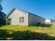 Image of the back of a home with vinyl siding, a covered patio, and a spacious backyard at 300 Saturn St, Dunn, NC 28334