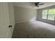 Neutral bedroom featuring carpet, neutral paint, a ceiling fan, and a bright window at 300 Saturn St, Dunn, NC 28334