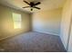 Comfortable bedroom featuring plush carpeting, neutral walls, and natural light from a window at 300 Saturn St, Dunn, NC 28334