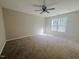 Spacious carpeted bedroom with a ceiling fan and large windows for plenty of natural light at 300 Saturn St, Dunn, NC 28334