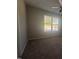 Cozy bedroom with soft carpet, a ceiling fan, and a window offering natural light and pleasant views at 300 Saturn St, Dunn, NC 28334