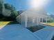 Inviting single-story home featuring a covered porch and a well-maintained driveway, nestled within lush greenery at 300 Saturn St, Dunn, NC 28334