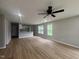 Spacious living room with new flooring, neutral paint, ceiling fan, and lots of natural light at 300 Saturn St, Dunn, NC 28334