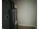 Water heater in a utility closet with wood-look floors and white walls at 300 Saturn St, Dunn, NC 28334