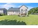 Well-maintained backyard featuring a spacious lawn and outdoor seating area for entertaining at 30155 Pharr, Chapel Hill, NC 27517