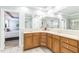 Bathroom featuring a double vanity with cabinets and large mirrors in a well-lit space at 30155 Pharr, Chapel Hill, NC 27517