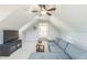 Large bonus room with gray sectional sofa, storage and vaulted ceiling at 30155 Pharr, Chapel Hill, NC 27517
