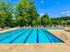 Community pool with lane markers, lounge chairs, and umbrellas for residents' enjoyment at 30155 Pharr, Chapel Hill, NC 27517