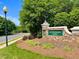 Stone community sign with lush landscaping under a bright blue sky at 30155 Pharr, Chapel Hill, NC 27517