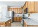 Modern kitchen featuring granite countertops, stainless steel appliances, and ample cabinet storage at 30155 Pharr, Chapel Hill, NC 27517