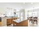 Bright kitchen with granite countertops, stainless steel appliances, and an island, adjacent to the dining area at 30155 Pharr, Chapel Hill, NC 27517