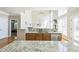 Open-concept kitchen with an island, granite countertops, stainless steel appliances, and ample natural light at 30155 Pharr, Chapel Hill, NC 27517