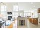 Open-concept living room with fireplace and seamless flow to the kitchen and dining area at 30155 Pharr, Chapel Hill, NC 27517
