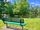 Park bench overlooks a tranquil pond surrounded by mature trees in a peaceful setting at 30155 Pharr, Chapel Hill, NC 27517