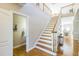 Elegant staircase leading to the upper level with natural light and hardwood floors at 30155 Pharr, Chapel Hill, NC 27517