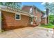 Charming brick home with an awning-covered back patio, perfect for outdoor relaxation and entertaining at 3027 Truitt Dr, Burlington, NC 27215