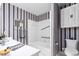 Bathroom with blue striped wallpaper and tub/shower combo at 3027 Truitt Dr, Burlington, NC 27215