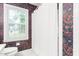 Bathroom featuring a window, toilet, and patterned wallpaper at 3027 Truitt Dr, Burlington, NC 27215