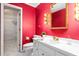 Bright bathroom features wallpaper, vanity, and walk-in closet at 3027 Truitt Dr, Burlington, NC 27215