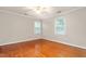 Bedroom with hardwood floors, ceiling fan and two windows at 3027 Truitt Dr, Burlington, NC 27215
