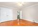 Bright bedroom featuring hardwood floors, a ceiling fan, and a closet with white doors at 3027 Truitt Dr, Burlington, NC 27215