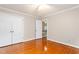 Cozy bedroom with hardwood floors, a ceiling fan, and a closet with white doors at 3027 Truitt Dr, Burlington, NC 27215
