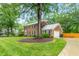 Spacious brick home with a large yard, driveway, and a detached garage at 3027 Truitt Dr, Burlington, NC 27215