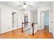 Upstairs hallway with wood floors and a ceiling fan at 3027 Truitt Dr, Burlington, NC 27215