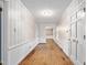 Entry hallway with hardwood floors, neutral walls, and multiple doorways at 3027 Truitt Dr, Burlington, NC 27215