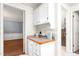 Hallway with a glimpse of a powder room with ample storage cabinets and countertop space at 3027 Truitt Dr, Burlington, NC 27215