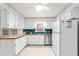 Well-lit kitchen featuring white appliances, wood countertops, and ample cabinet space at 3027 Truitt Dr, Burlington, NC 27215