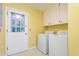 Functional laundry room with appliances and overhead storage at 3027 Truitt Dr, Burlington, NC 27215