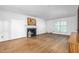 Spacious living room featuring a fireplace, hardwood floors, and a large window at 3027 Truitt Dr, Burlington, NC 27215