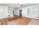 Inviting living room featuring hardwood floors, staircase, and multiple windows for natural light at 3027 Truitt Dr, Burlington, NC 27215