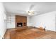 Classic living room featuring a red brick fireplace, built-in shelving, and hardwood floors at 3027 Truitt Dr, Burlington, NC 27215