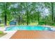 The home has a beautiful swimming pool with a diving board surrounded by mature trees at 3027 Truitt Dr, Burlington, NC 27215