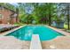Home's inviting pool features a diving board and steps for easy access and enjoyment at 3027 Truitt Dr, Burlington, NC 27215