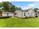 Backyard with manicured lawn, detached garage, and outdoor seating area at 305 Georgetown Rd, Raleigh, NC 27608